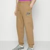 BOSS X RUSSELL ATHLETIC JAFA - Tracksuit Bottoms - Medium Beige -BOSS Sales Store 43250e30a48443c7b2663967b8e4be7b