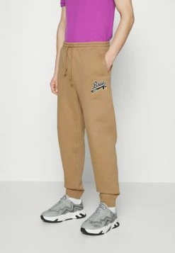 BOSS X RUSSELL ATHLETIC JAFA - Tracksuit Bottoms - Medium Beige